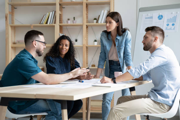 istock Focused mixed race business people company employees discussing project. 1208424347