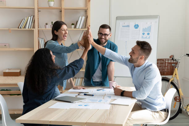 istock Overjoyed young mixed race employees celebrating shared business success. 1208424349