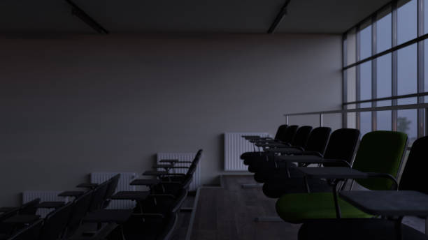 istock Side View of Back Rows Inside a Lecture Room in Low Light 1208428950