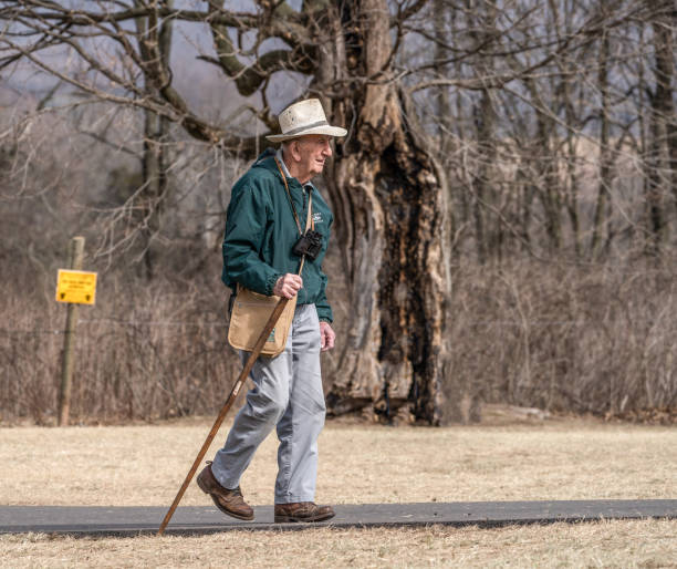 Older Gentleman Taking Walk in Park stock photo