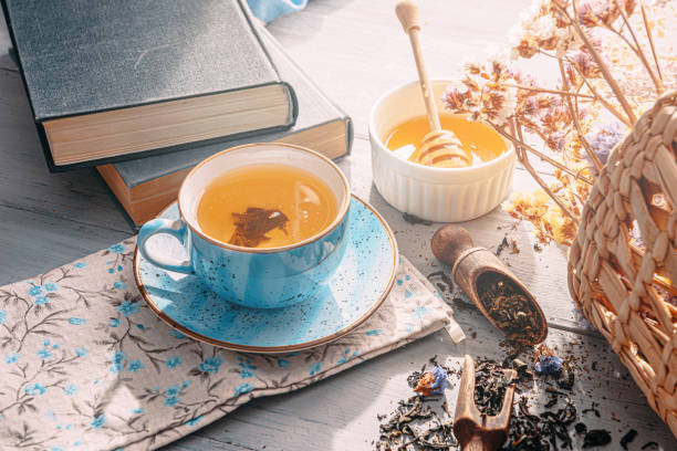 istock warm tea and a book in the sunshine 1208431535