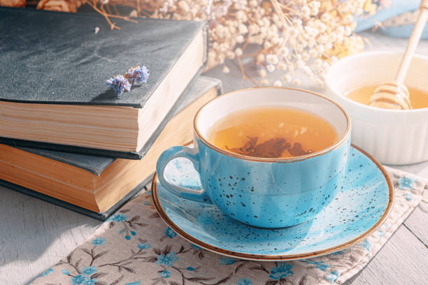 istock warm tea and a book in the sunshine 1208431578