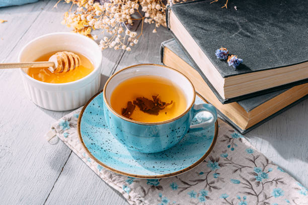 istock warm tea and a book in the sunshine 1208431676