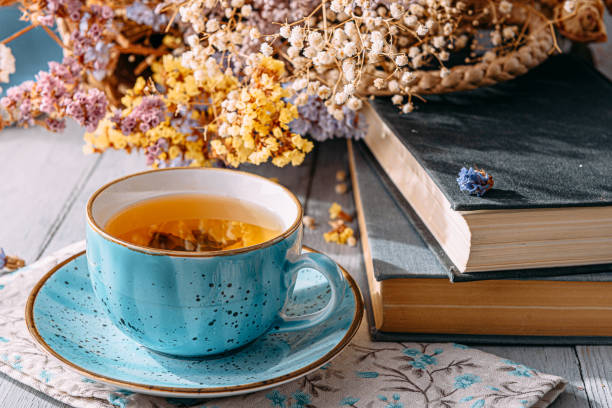 istock warm tea and a book in the sunshine 1208431718