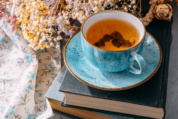 istock warm tea and a book in the sunshine 1208431732