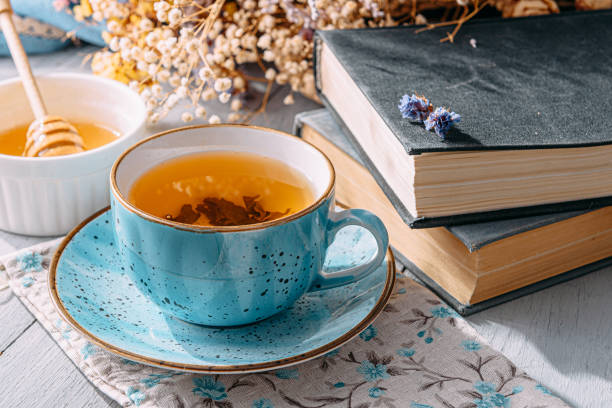 istock warm tea and a book in the sunshine 1208431741