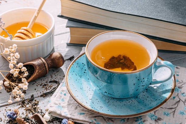 istock warm tea and a book in the sunshine 1208431790