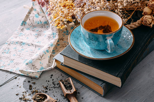 istock warm tea and a book in the sunshine 1208431804