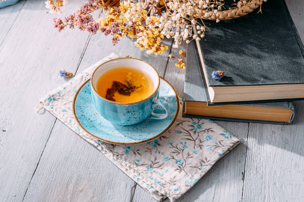 istock warm tea and a book in the sunshine 1208431836