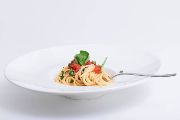 istock Spaghetti dish with basil, tomato and shredded herbs 1208432920