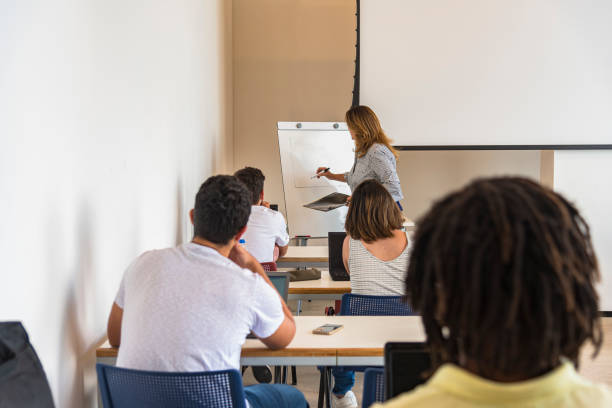 istock Brazilian university students with a teacher in the classroom, during content explanation 1208434433