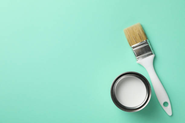 istock Paint can and brush on green background, top view 1208434915