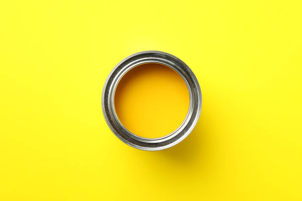 istock Paint can on yellow background, top view 1208435898