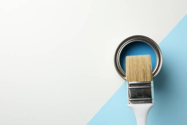 istock Paint can and brush on two tone background, top view 1208436161