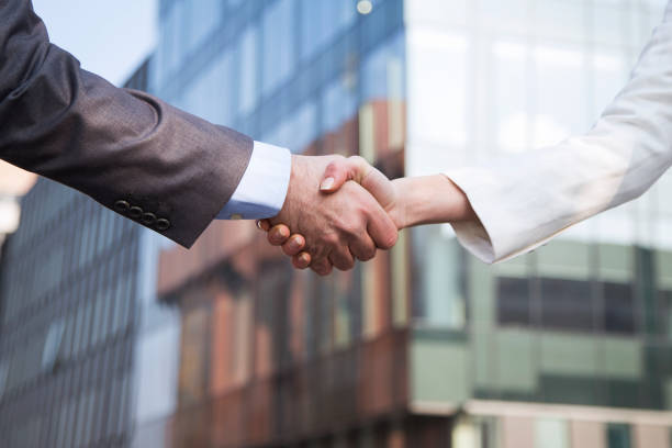 istock Two business people shaking hands 1208436399