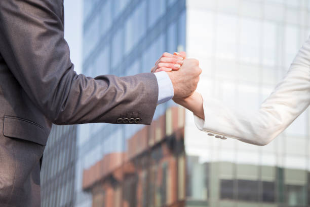istock Two business people shaking hands 1208436402