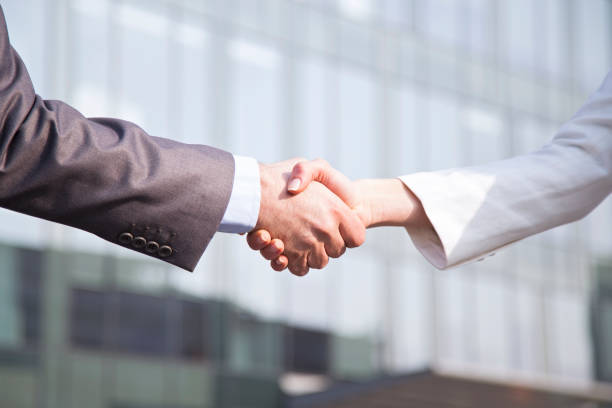 istock Two business people shaking hands 1208436935