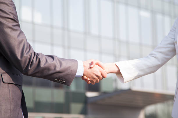 istock Two business people shaking hands 1208436961