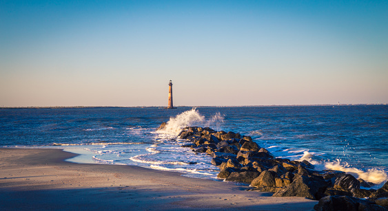 Rocky breakwater leading to an lighthouse in South Carolina