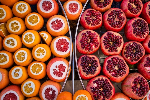 Istanbul, Turkey - January 10, 2020: Delicious juicy fruits amazingly colored at a street shop, selling grapefruits, pomegranates, oranges and other pleasant fruits to taste and to view, in day time, in Istanbul, Turkey.