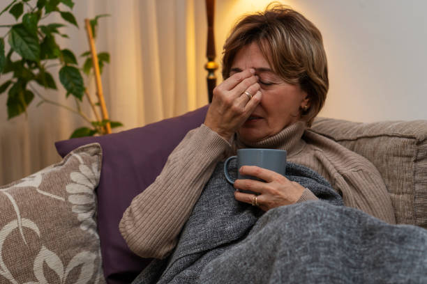 istock Senior woman feeling sick at home 1208443118