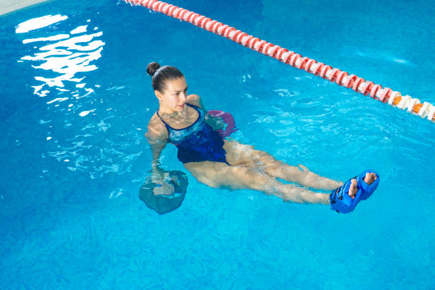 istock Young woman doing water aerobics in indoor pool, sporting concept 1208444280