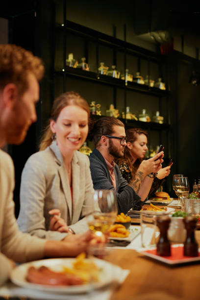 istock Group of best friends sitting in restaurant, having dinner, drinking wine and having fun. 1208446587