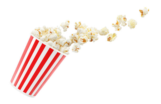 Popcorn falling out of red striped paper cup on white