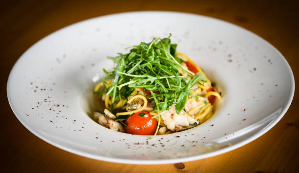 istock delicious fresh italian pasta with fish & rucola salad 1208447651