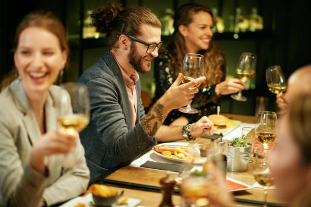 istock Group of best friends sitting in restaurant, having dinner, drinking wine and having fun. 1208447712