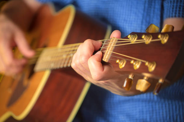 istock Man playing an acoustic guitar during a concert 1208447801