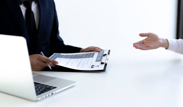 istock Business people hold resume documents, interviews for the work experience of young men applying as financial accountants for the company, Job interview and Job applicationConcept. 1208448399