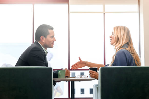istock Coworkers or a professional and a client have a discussion 1208453830