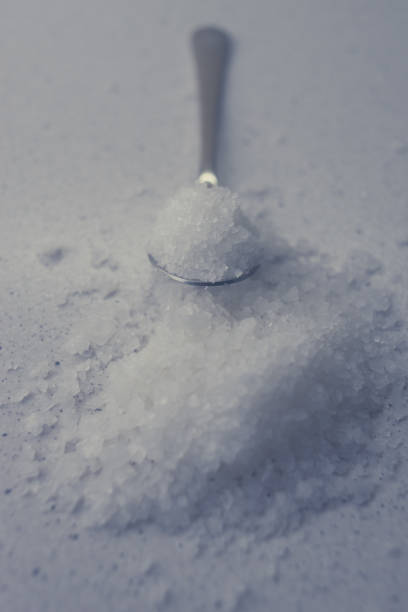 istock sea salt on the marble table and in spoon. 1208455916