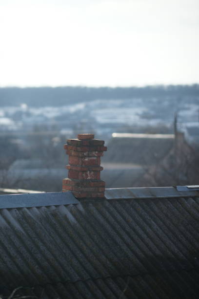 istock Old chimney in red bricks on the old rural roof 1208455978
