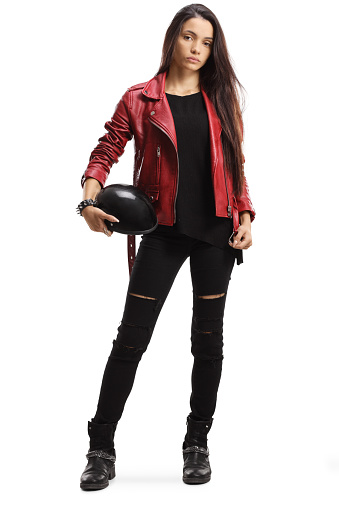 Full length portrait of a young female holding a motorbike helmet isolated on white background