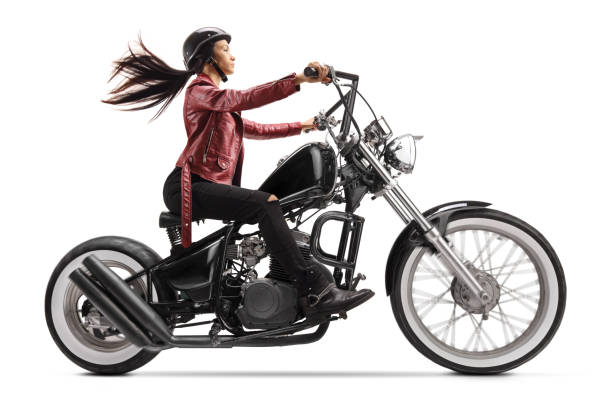 istock Young woman riding a custom black motorcycle 1208456224