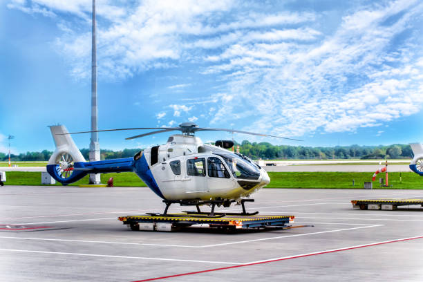 Helicopter chopper at airport on background of blue sky.