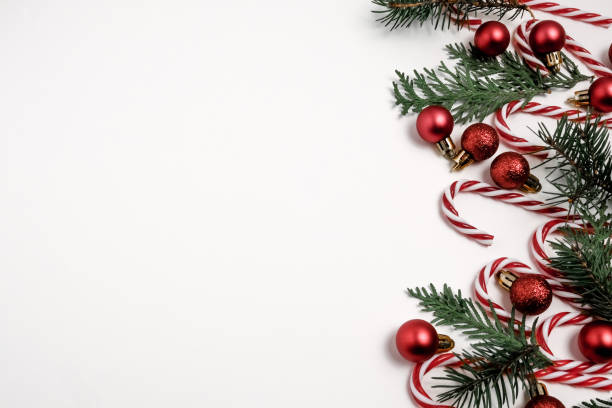 istock Christmas winter composition. Red and silver balls with candy canes on black background. Top view, flat lay 1208456927