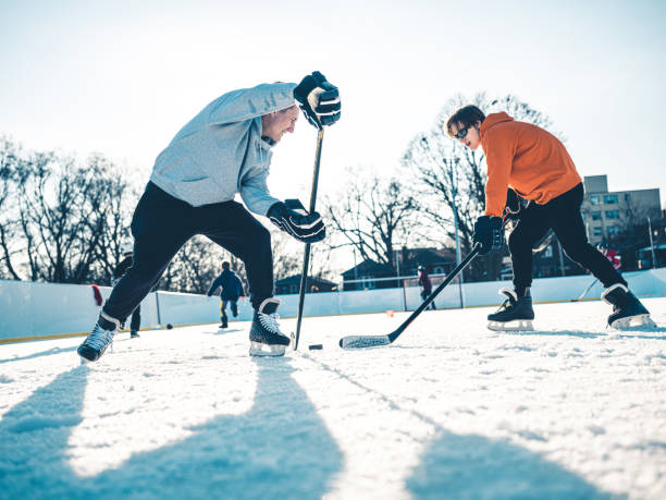 A family playing at the skating rink in winter.