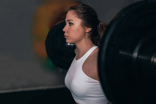 istock Athlete doing squart movements with weights, Close-up, heavy training. Healthy living. Leg running woman 1208458191
