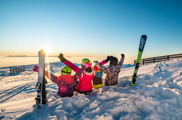 istock Family with hands raised on skiing 1208462575