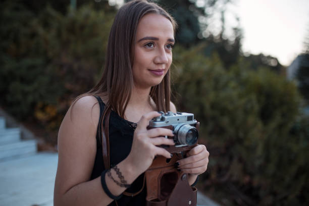 istock Young tourist with analog camera 1208468327