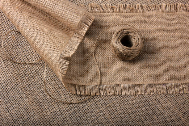 istock Linen rope roll and natural linen fabric texture. Linen background. 1208468333