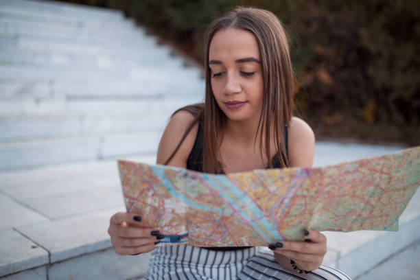 istock Woman tourist exploring city map 1208468979