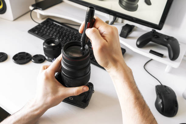 istock A man cleans the lens from dust and dirt with a special pencil. 1208470291