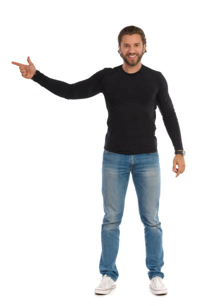 istock Confident Man Is In Black Blouse, Jeans And Sneakers Is Directing 1208470535