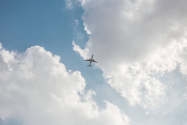 istock an airplane flying in the clear sky 1208474197