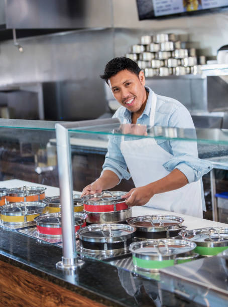 istock Man working in open kitchen of restaurant 1208475437