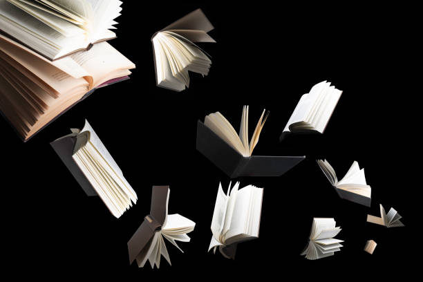 Flying several books isolated on black background. stock photo